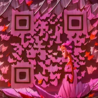 QR Code Expert beautiful example: Woman in a pink dress with autumn leaves.